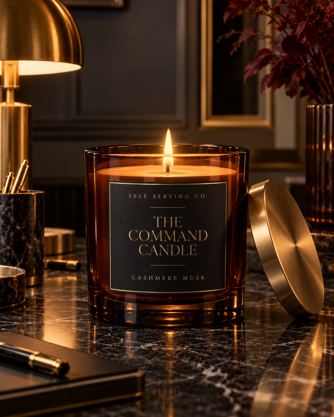 The Command Candle Cashmere Musk amber glass and brushed brass editorial hero